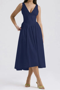 Navy blue dress worn by a model on a white background