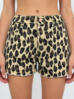 Leopard print shorts worn by a person on a plain background