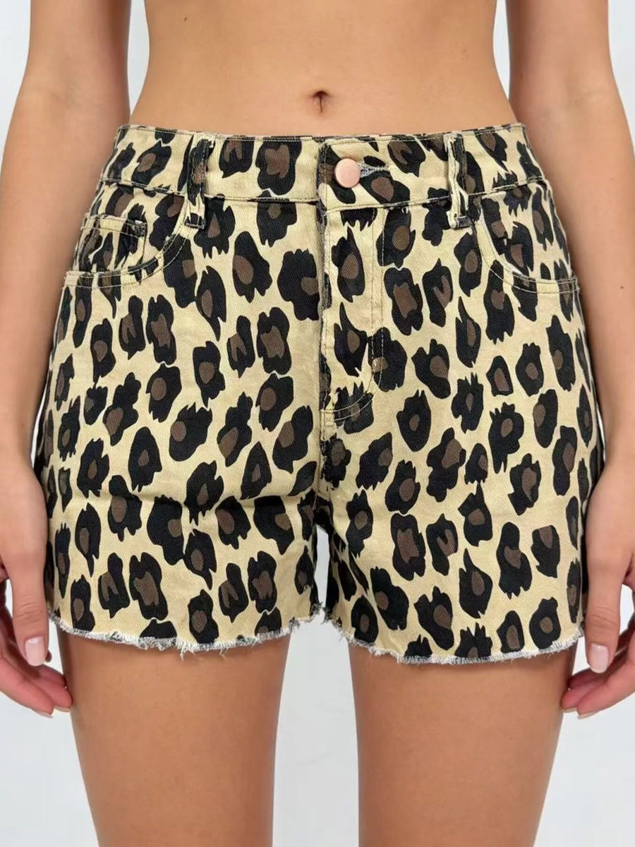 Leopard print shorts worn by a person on a plain background