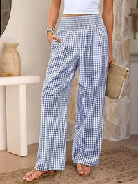 Person wearing blue and white checkered pants in a home setting.