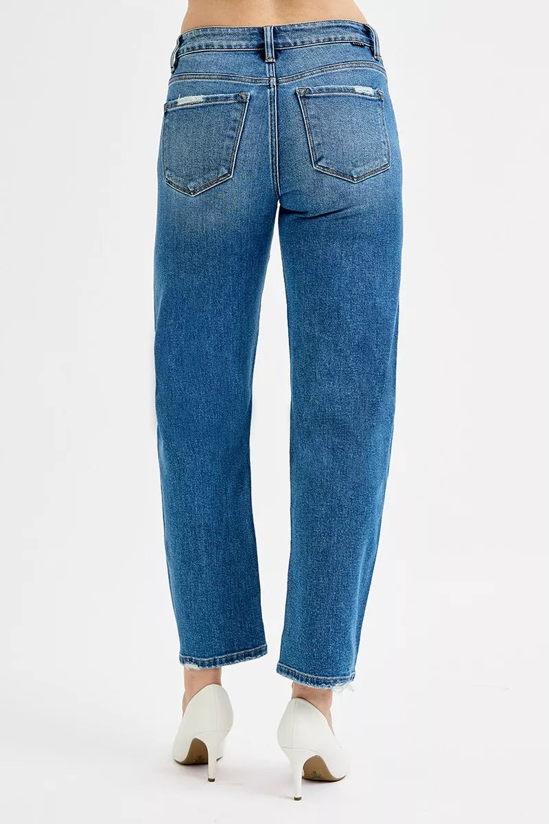 Blue jeans worn by a person on a white background