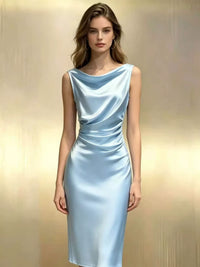 Woman wearing a light blue satin dress against a plain background