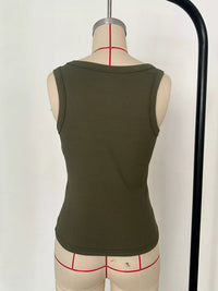 Green tank top on a mannequin with underwear underneath against a white background