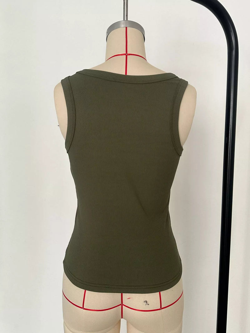 Green tank top on a mannequin with underwear underneath against a white background