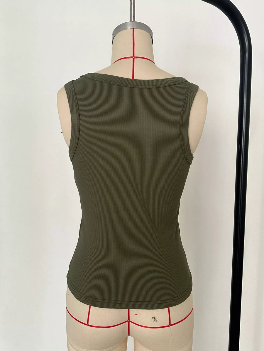Green tank top on a mannequin with underwear underneath against a white background