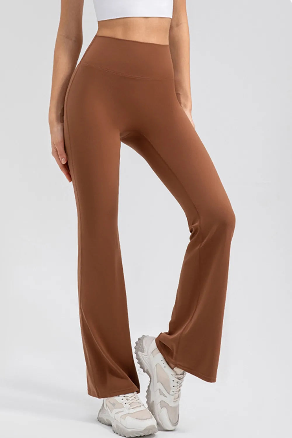 Brown wide-leg pants worn by a person on a white background