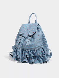 Light blue denim backpack with ruffled bottom on a white background