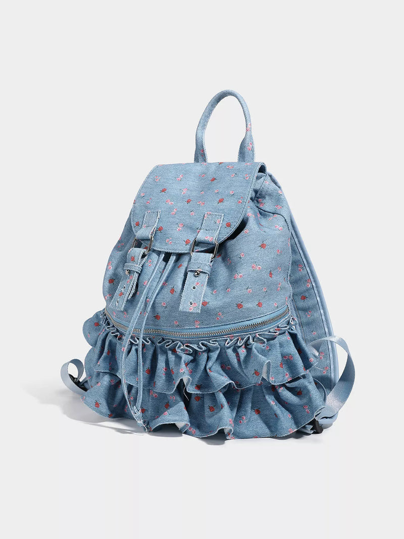 Light blue denim backpack with ruffled bottom on a white background