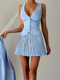 Light blue dress with pleated skirt on a plain background