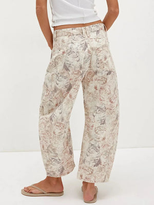 Person wearing floral pants on a white background