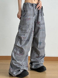 Plaid pants with text pattern worn by a person on a plain background