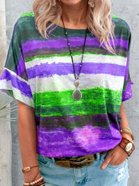 Person wearing a colorful striped shirt with a gray background