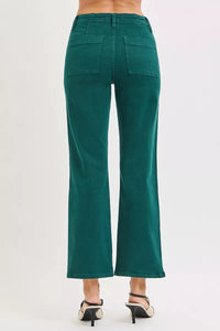 Green pants worn by a person on a white background