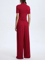 Red jumpsuit worn by a person on a white background