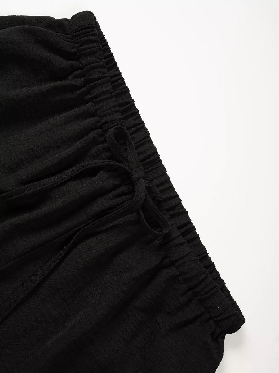 Black fabric with ruched texture on a white background