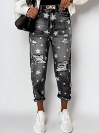 Person wearing star-patterned jeans with a white background