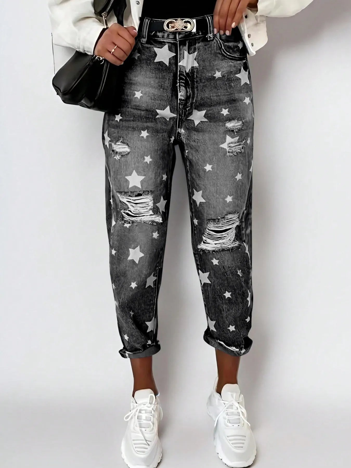 Person wearing star-patterned jeans with a white background