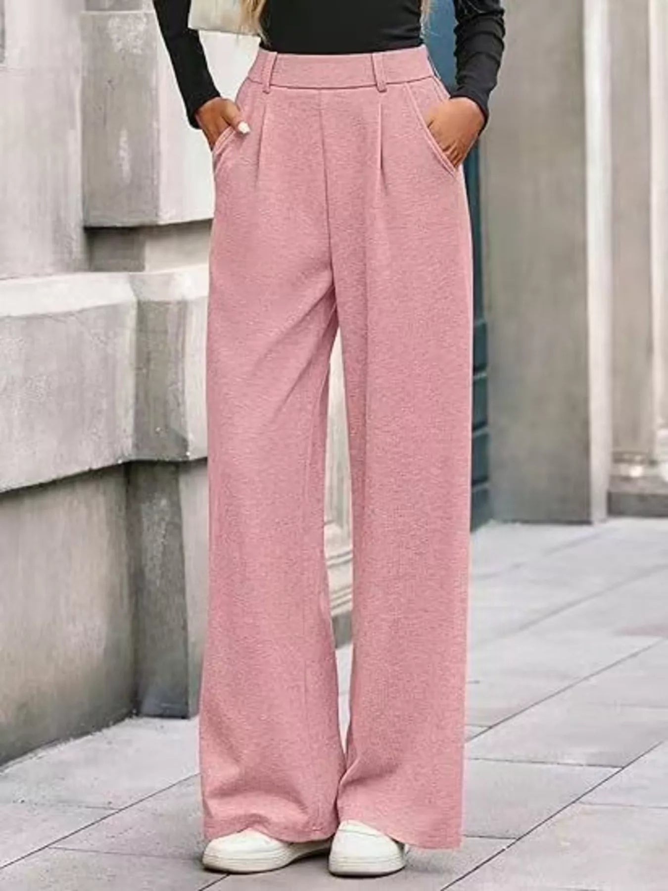 Person wearing pink wide-leg pants with a blurred background