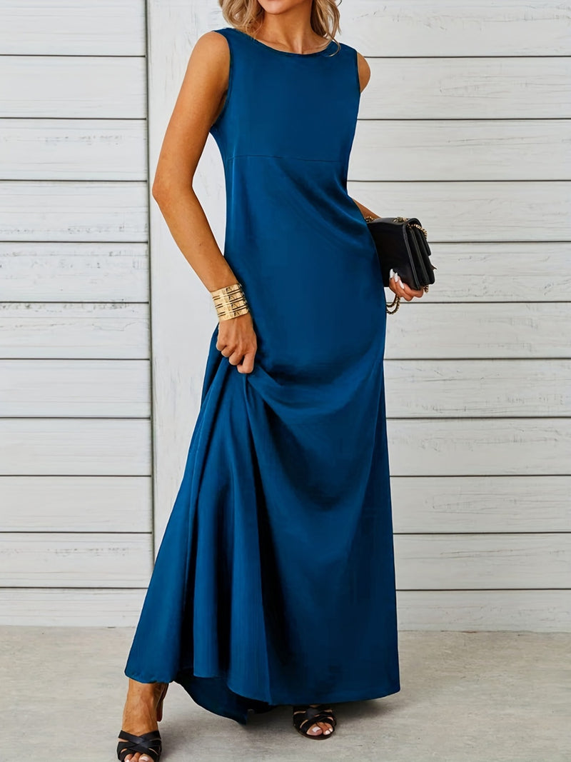 Woman wearing a blue sleeveless dress against a light wooden panel background