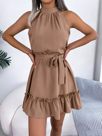 Woman wearing a beige dress with a white background