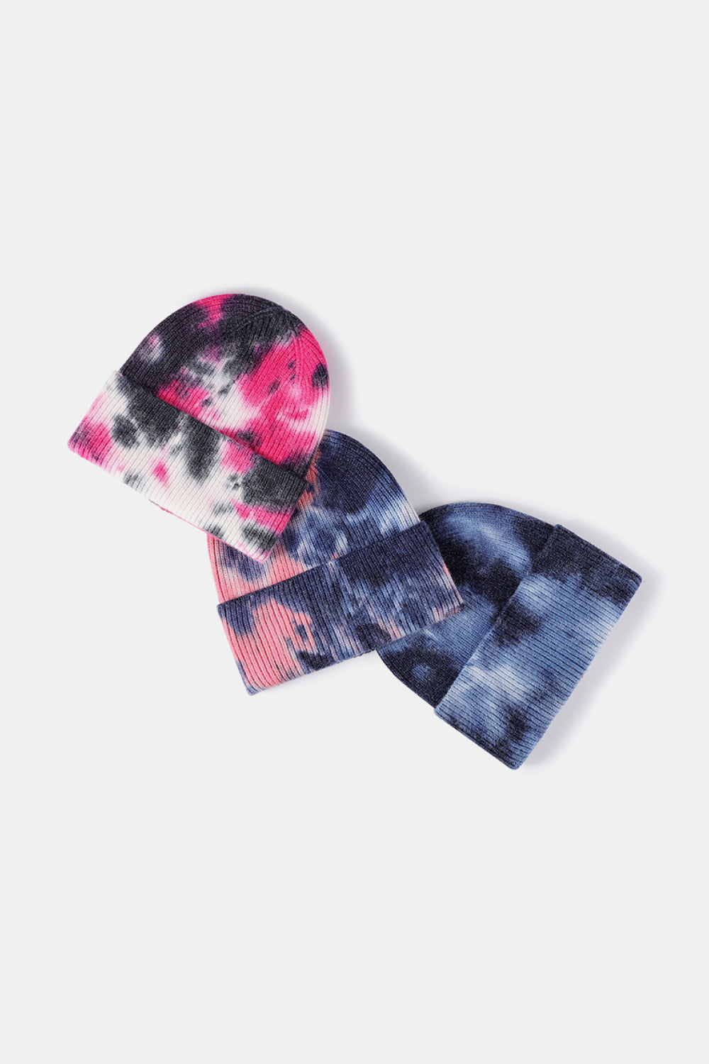 Set of tie-dye beanies on a white background