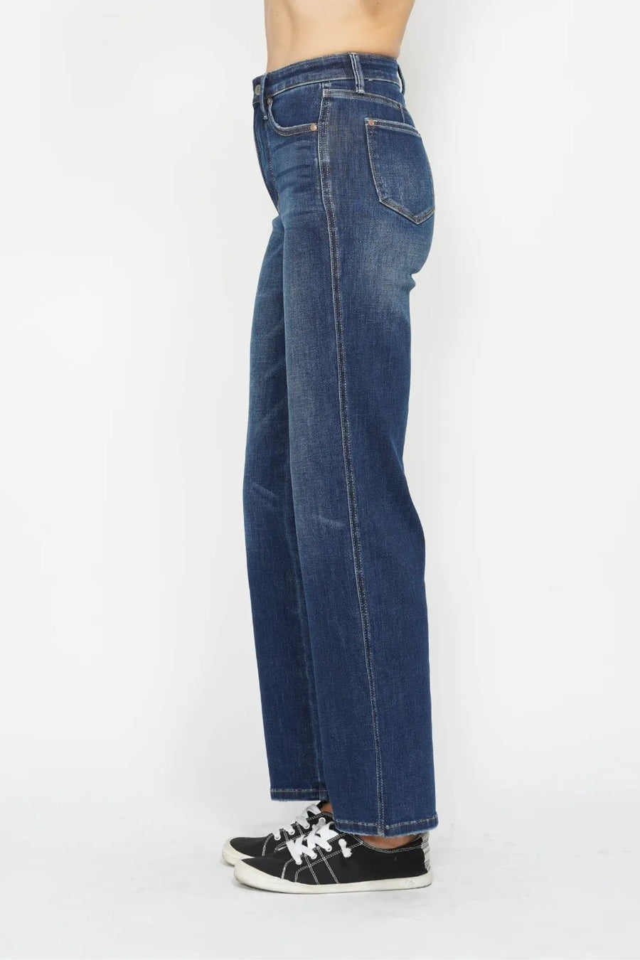 Blue jeans worn by a person on a white background