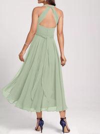 Green dress with open back on a white background