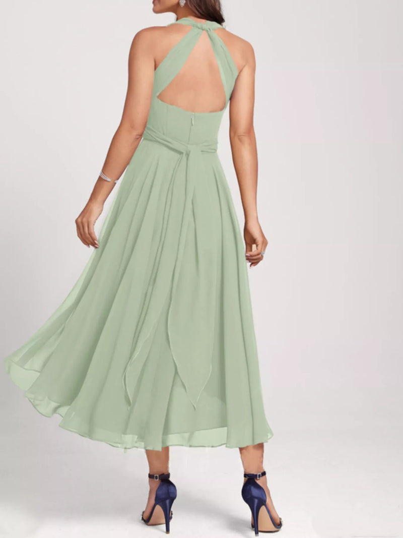 Green dress with open back on a white background