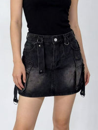 Black denim skirt worn by a person on a white background