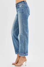 Blue jeans worn by a person on a white background