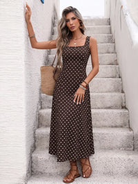 Woman in a polka dot dress standing on a staircase