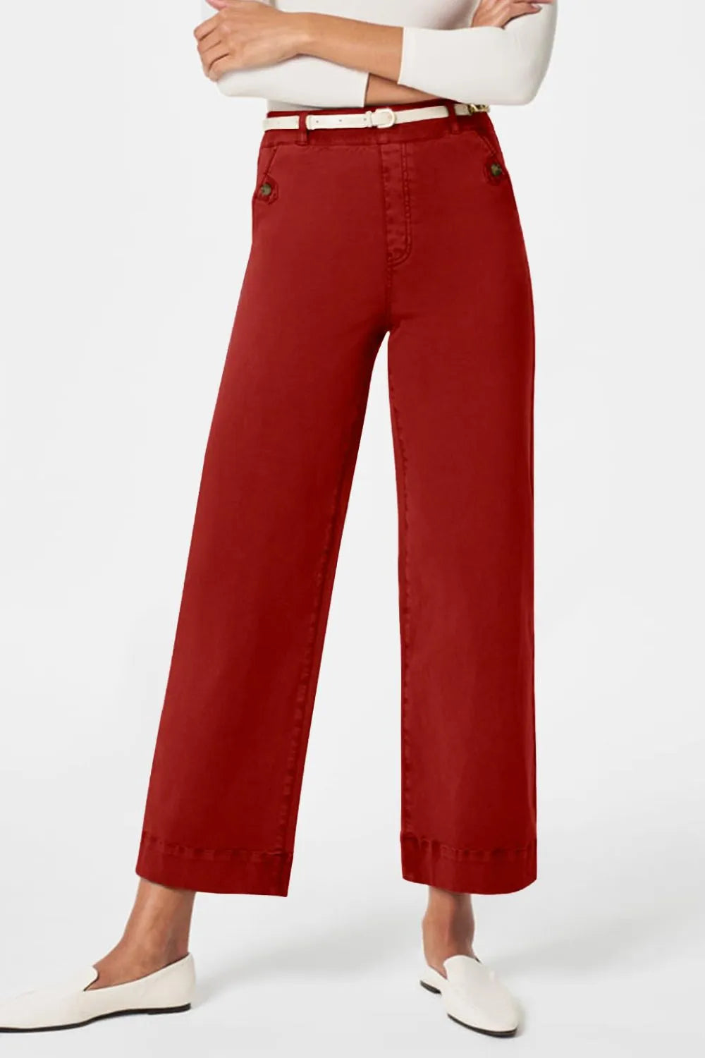 Red pants worn by a person on a white background
