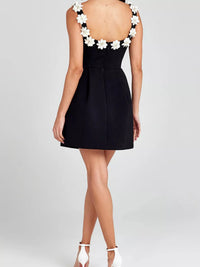 Black dress with floral back design on a white background