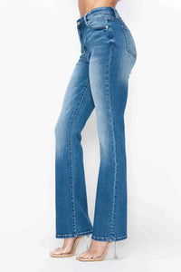 Blue jeans worn by a person on a white background