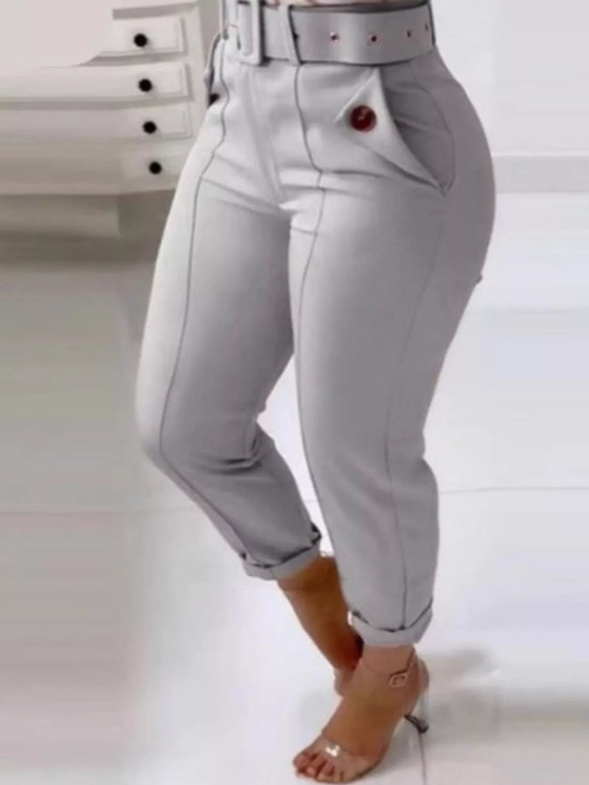 Gray pants worn by a person on a white background