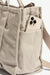closeup view of the cell phone pocket of Sloane Tote - Taupe