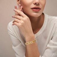 Lady wearing B.Tiff Pavé High Polish Gold Flat Angular Cuban Link Bracelet