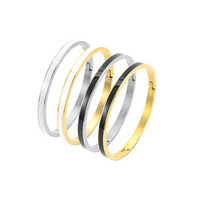 A view of four B.Tiff "The Hamptons" White Enamel Gold Bangle Bracelet