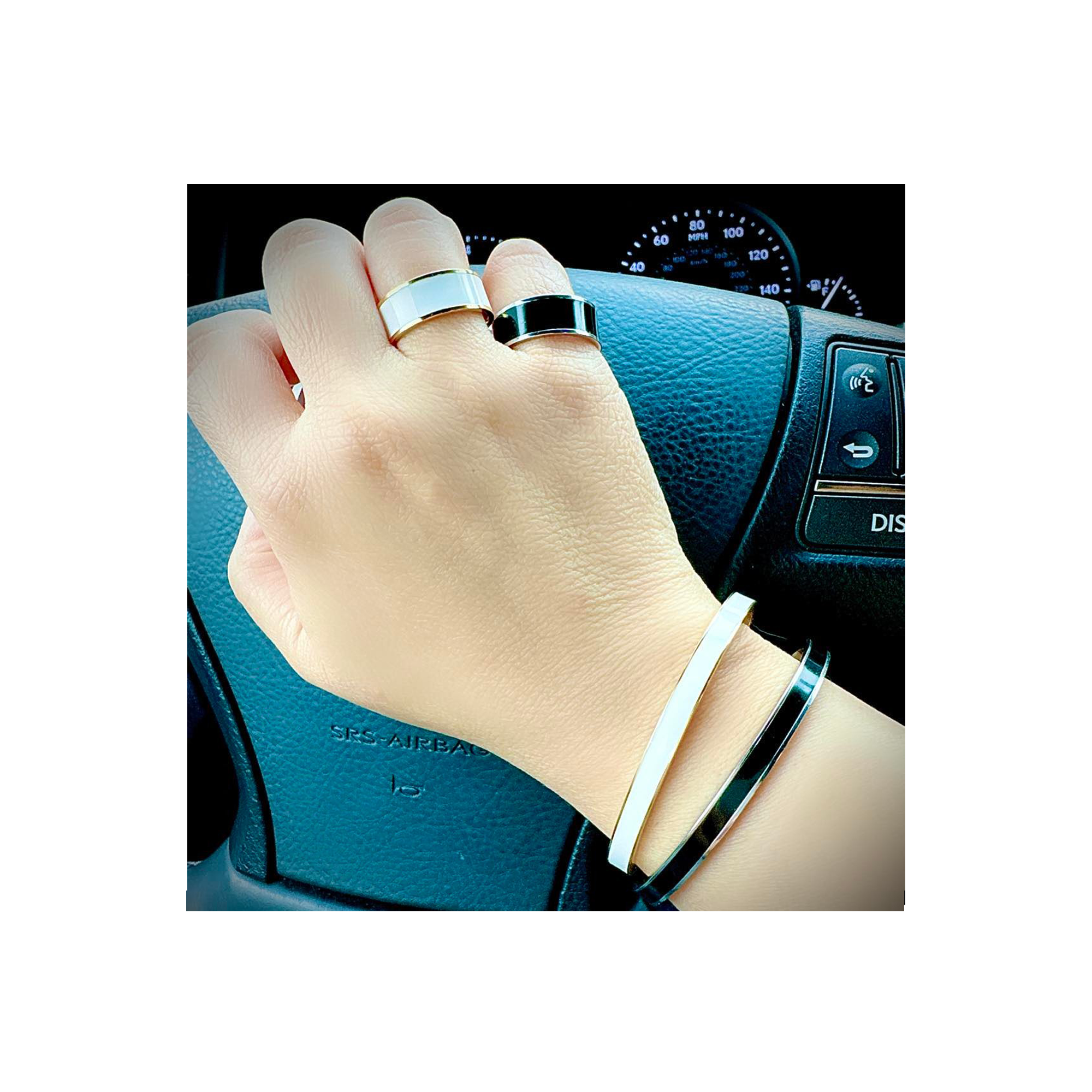 A lady driving a car wearing B.Tiff "The Hamptons" White Enamel Gold Bangle Bracelet