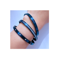 Lady has three B.Tiff 8-Stone Blue Bangle Bracelet on her arm