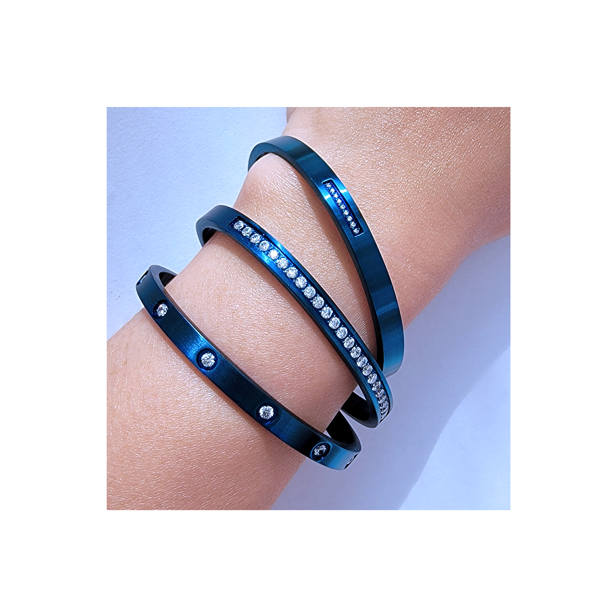 Lady has three B.Tiff 8-Stone Blue Bangle Bracelet on her arm