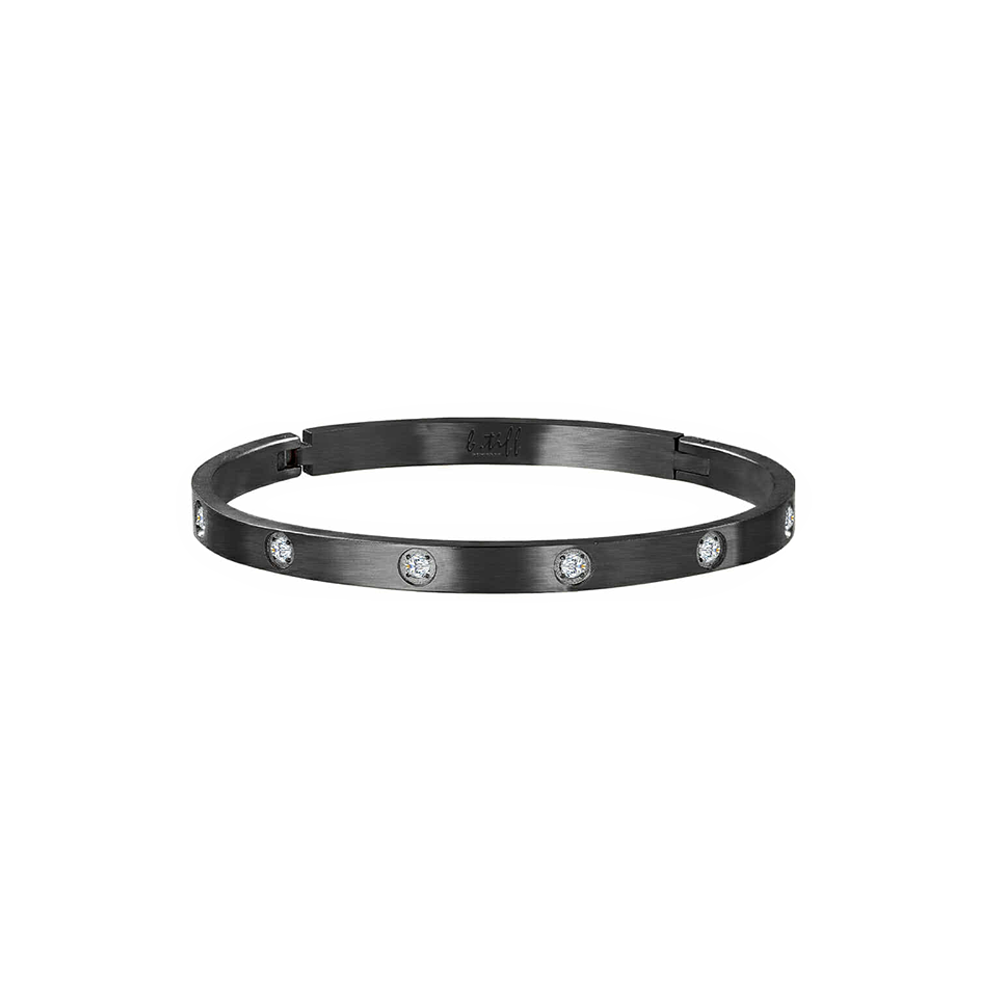 A black bangle bracelet with embedded stones, showcasing a pattern of stones around its circumference.