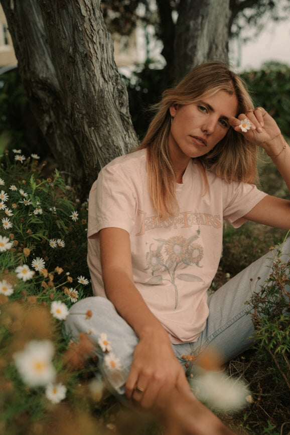 Model in the field of flowers wearing Tears for Fears Sowing the Seeds of Love Tee