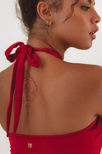 Close up view of the tie strap on red Iliana Cross-Over One Piece Swimsuit