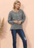 model posing in gray sweater