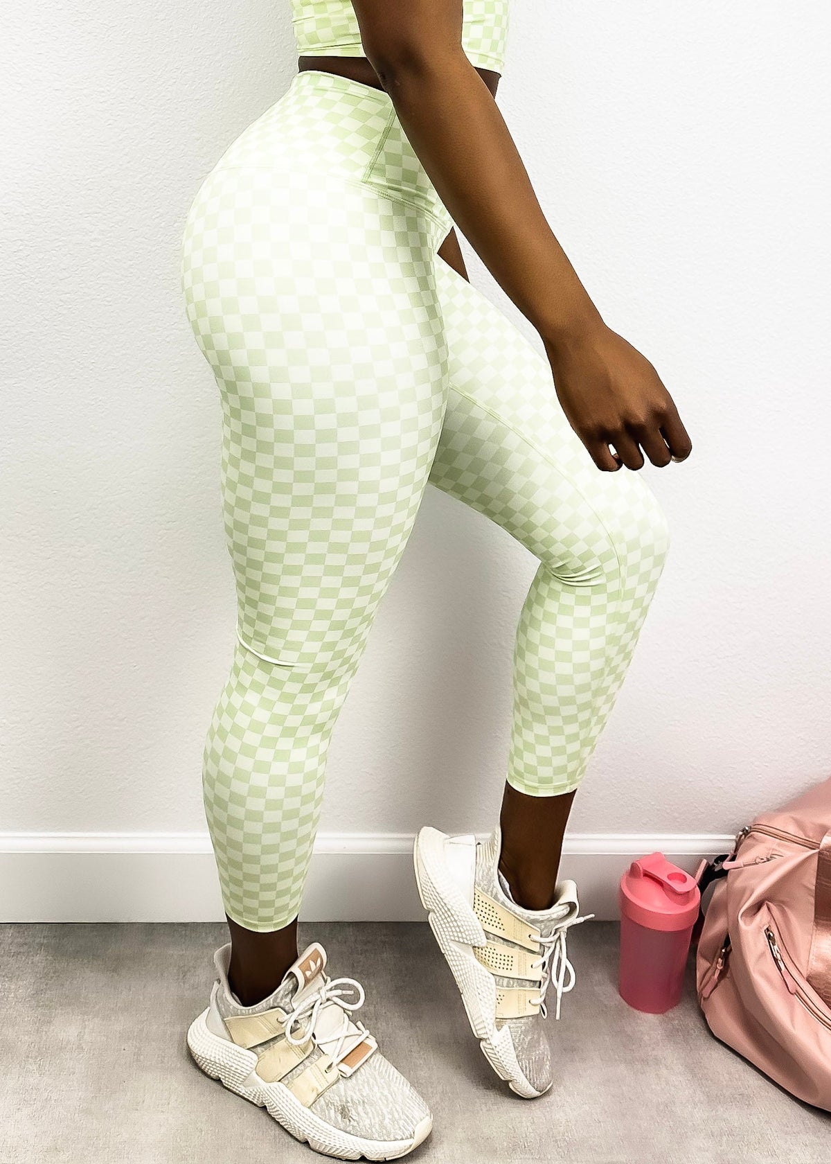 Model with one leg in front of the other showing Checkered High Rise 7/8 Leggings-light green