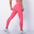 Model showing how pink leggings fit her curves 