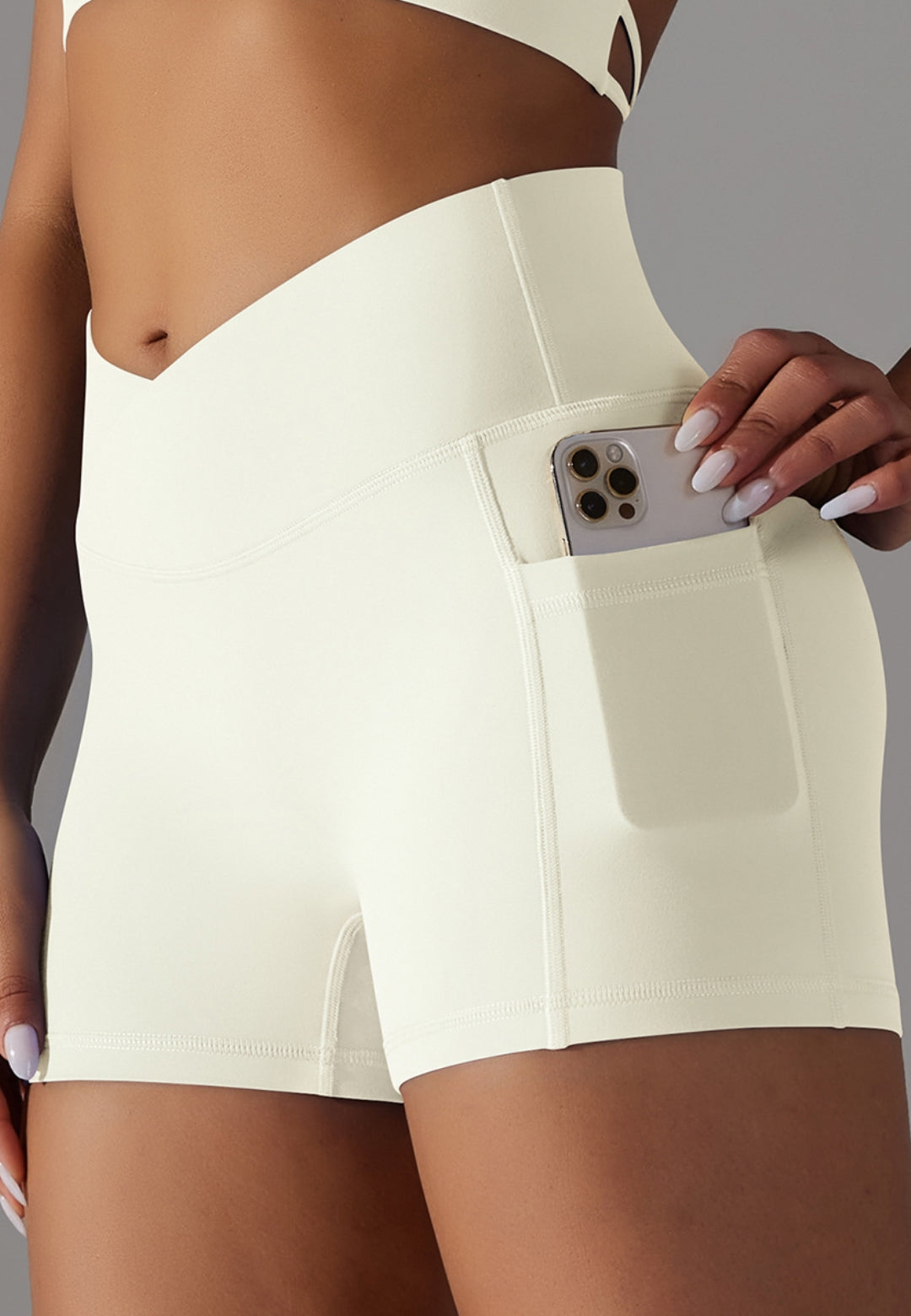 View of cell phone in the pocket of V-Waist Cross Back Shorts