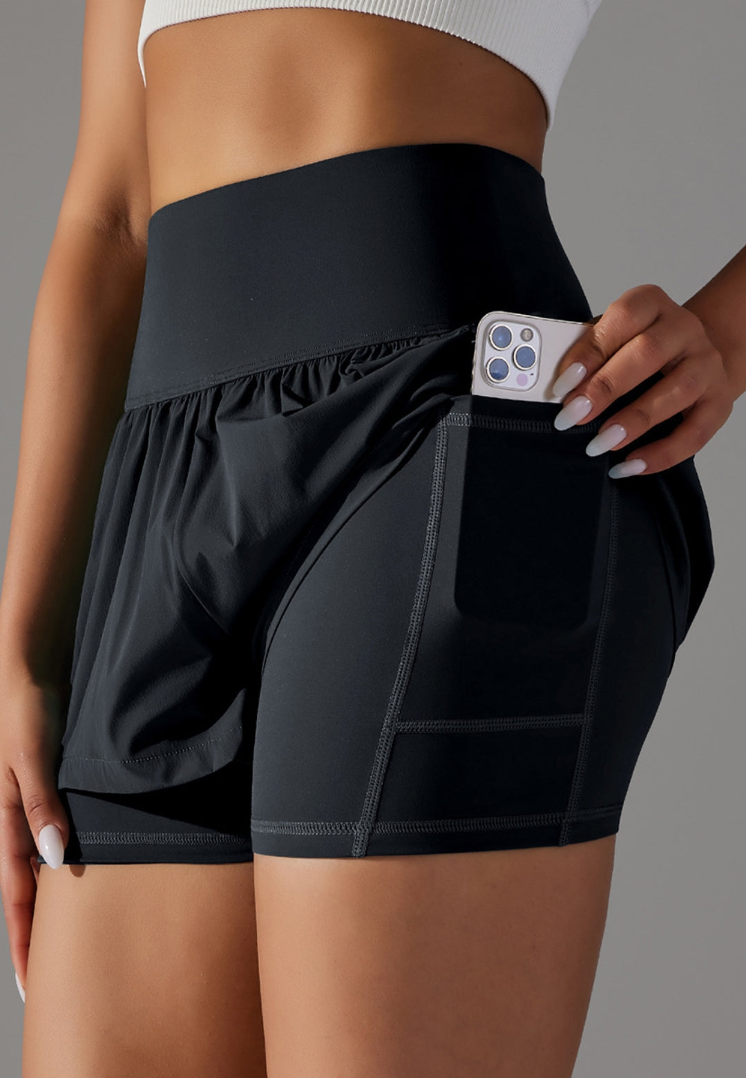 Model showing cell phone in the pocket of High Waist Ruffle Shorts