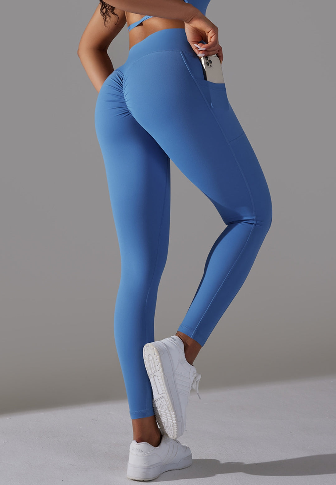 Model showing cell phone pocket from side on Overlap V-Waist Pocket Leggings